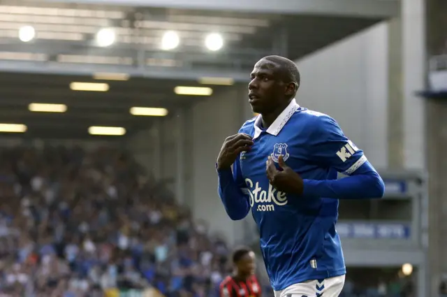 Doucoure runs to the corner to celebrate his goal with the fans.