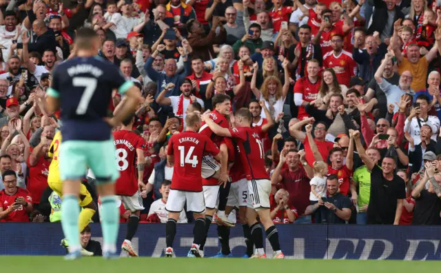 United celebrate as Brentford players stand shellshocked.