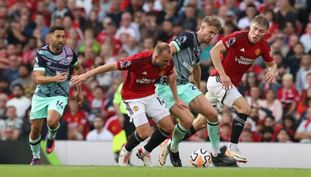 Brentford players swarm Eriksen on the ball.