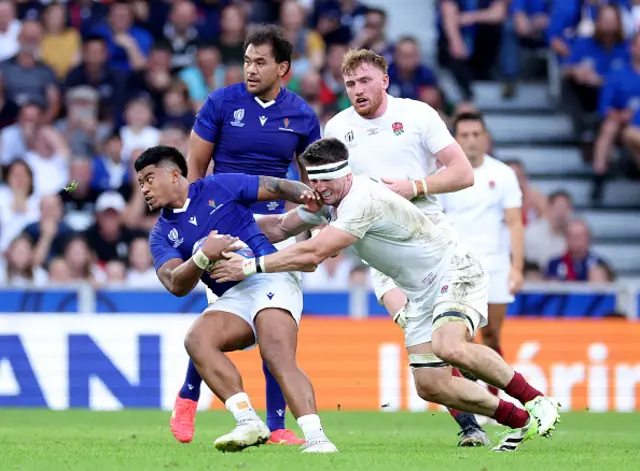 Danny Toala of Samoa is tackled by Tom Curry