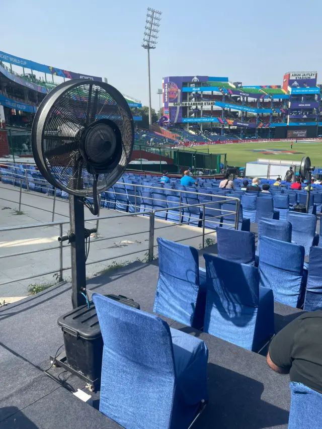 A picture of a fan next to seats at Arun Jaitley Stadium, Delhi