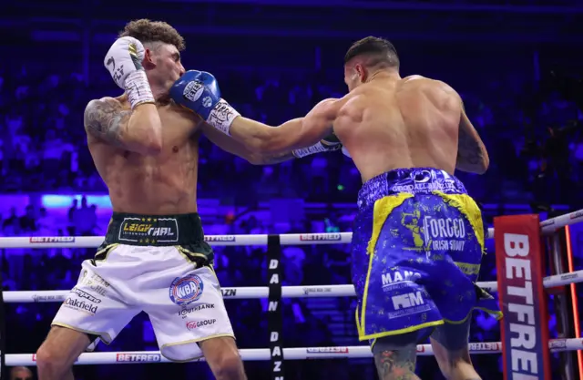 Leigh Wood is punched by Josh Warrington