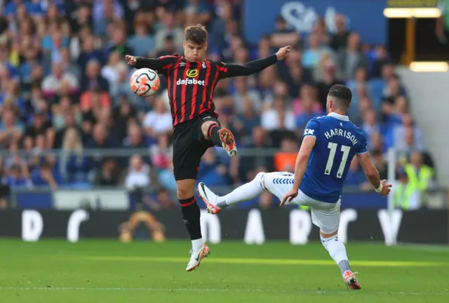 Kerkez challenges Harrison for the ball in mid air.