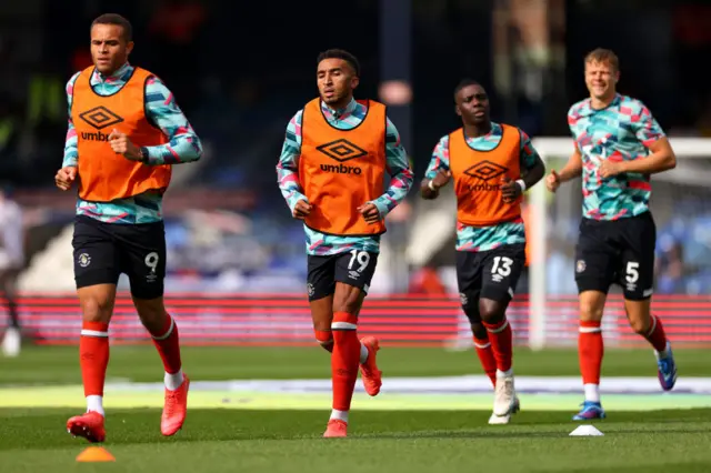 Luton players undergo a running drill in the warm up.