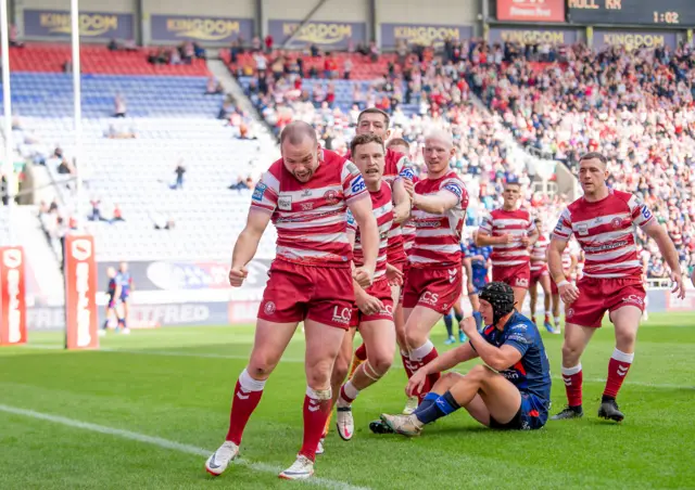 Liam Marshall celebrates his second try for Wigan