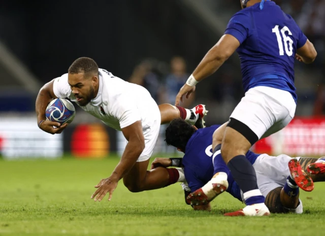 Ollie Lawrence runs with the ball into contact