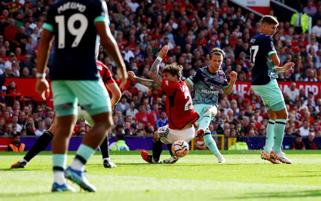 Jensen fires through a crowd of bodies in the box to give Brentford the lead.