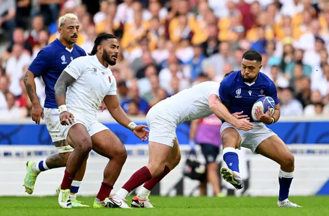 Duncan Paia'aua of Samoa is tackled by Owen Farrell