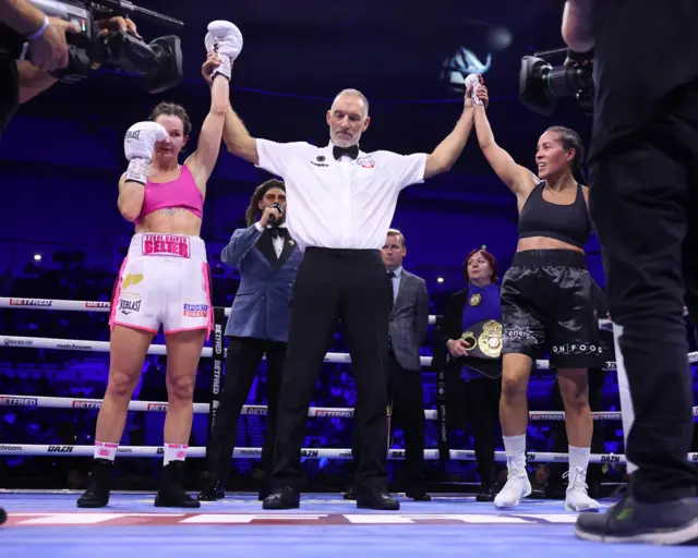 Terri Harper and Cecilia Braekhus with their hands in the air as fight announced a draw