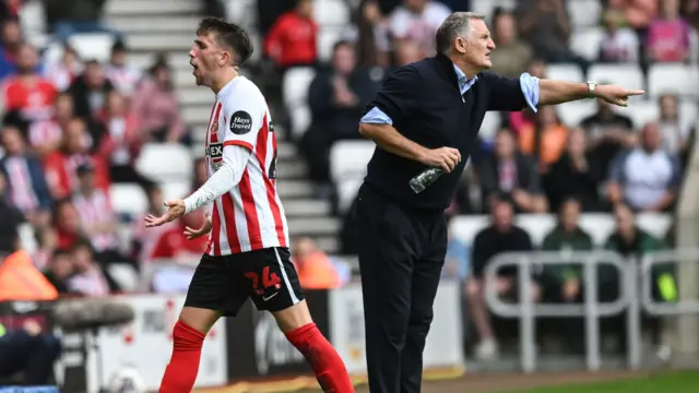 Dan Neil walks past Tony Mowbray