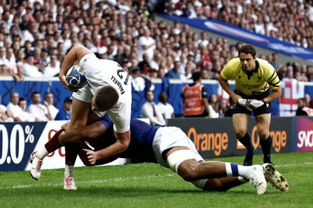 England's centre Owen Farrell is tackled into touch