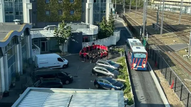 Georgia team standing in circle in car park