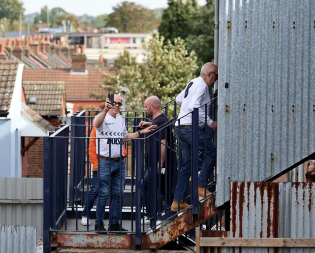 Tottenham fans video the interesting entrance to Luton's away end.