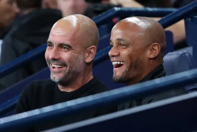 Guardiola and Kompany share a laugh on the City bench.