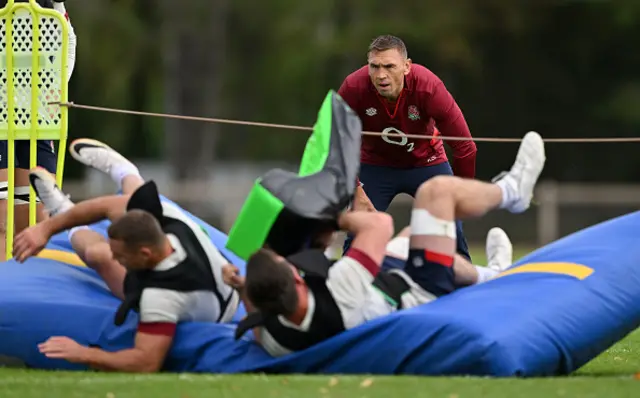 Kevin Sinfield looks on during training as players land on tackle mat