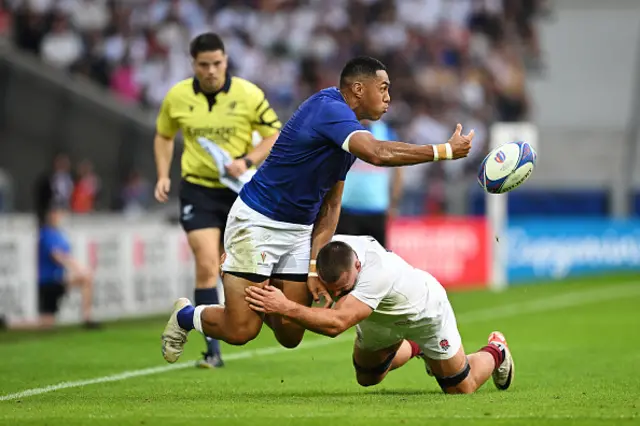 Nigel Ah-Wong of Samoa offloads the ball while being tackled by Ben Earl