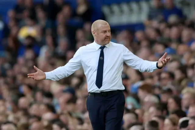 Sean Dyche asks the question of the fourth official with his arms out wide.