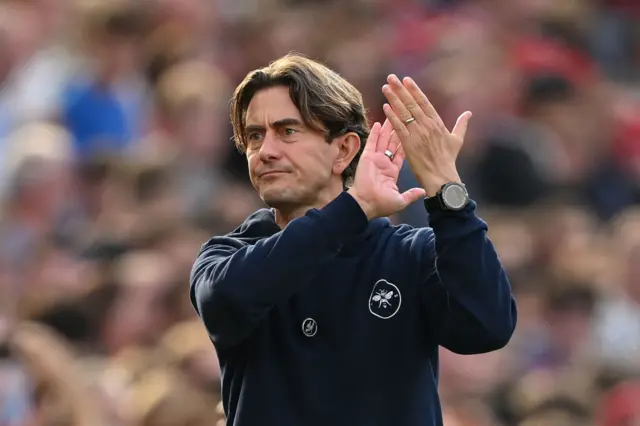 Frank applauds the travelling fans at Old Trafford.