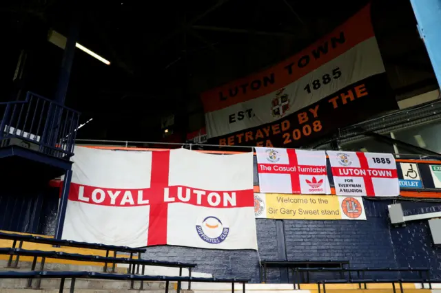 Luton Town flags hang in the home end of the ground.