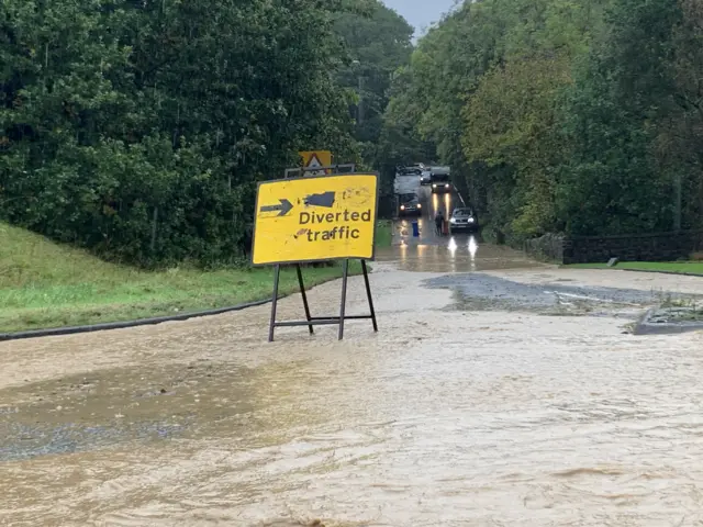 Flood around diversion sign