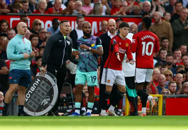 Rashford high fives Garnacho as he leaves the field.