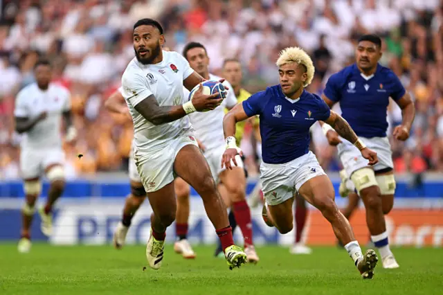 Manu Tuilagi of England breaks with the ball