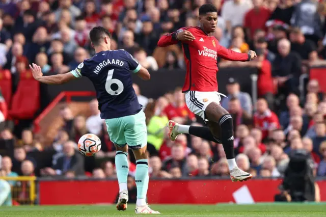 Rashford tries to win the ball in the air from Norgard.