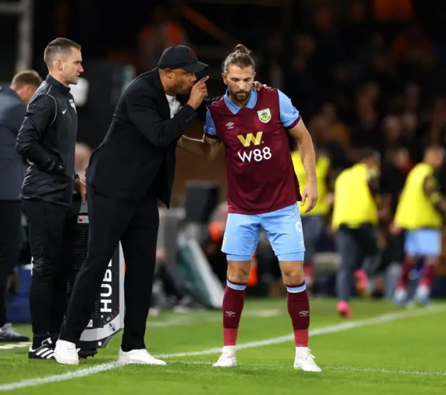 Kompany whispers instructions into the ear of Rodriguez.