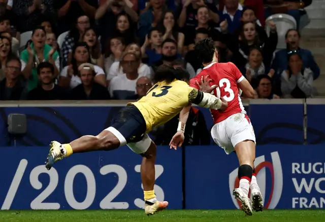 Tonga's wing Kyren Taumoefolau runs to score a try