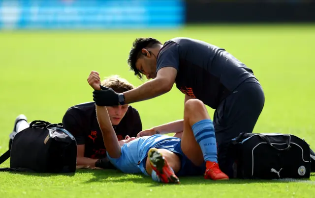 Hemp's injured arm is worked on by City medics as she lies on the floor.