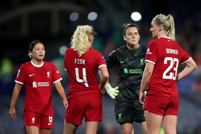 Liverpool defence and keeper chat before the game restarts.