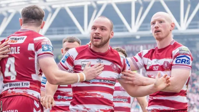 Liam Marshall celebrates one of his three tries for Wigan