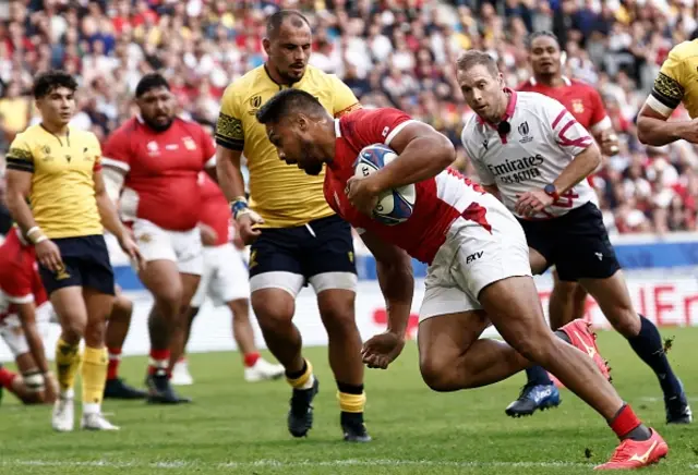 Tonga's outside centre George Moala runs to score a try