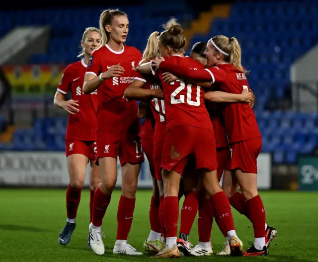 Liverpool huddle to celebrate Hobinger's opening goal.