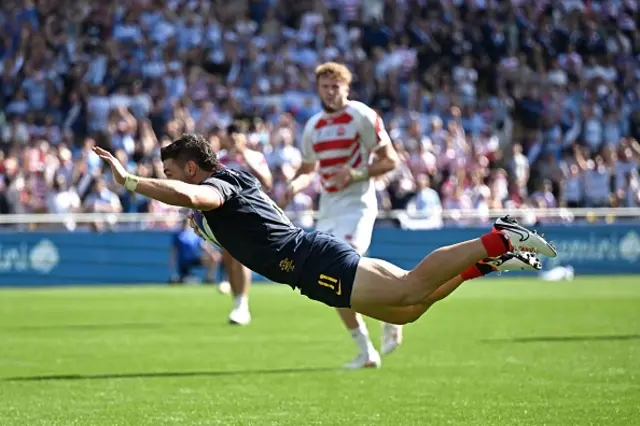 Argentina's left wing Mateo Carreras dives to score a try