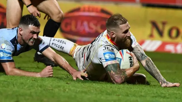 Sam Tomkins dives to score for Catalans as Lewis Dodd stretches in despair