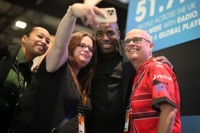 David Lammy poses for a selfie with three other people