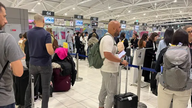 People standing around Larnaca International Airport in Cyprus