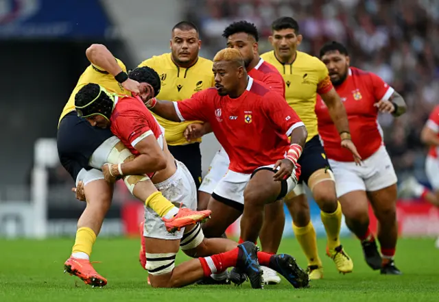 Ovidiu Cojocaru of Romania is tackled by Adam Coleman of Tonga