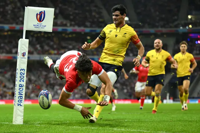 Kyren Taumoefolau of Tonga dives in the corner to score