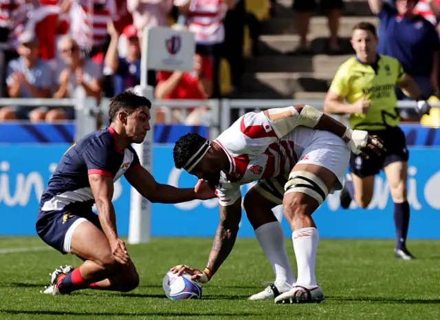 Amato Fakatava of Japan scores as Santiago Carreras  attempts a last ditch tackle