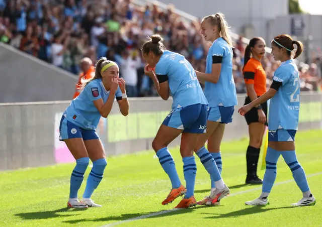 Chloe Kelly does a signature celebration with her teammates.