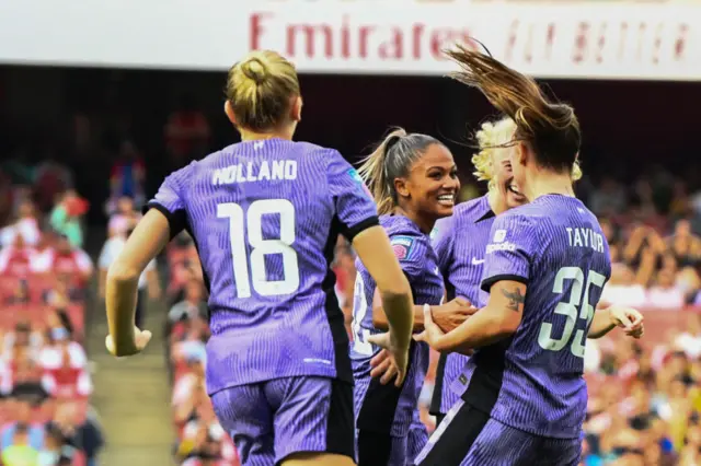 Liverpool players celebrate their goal at the Emirates.