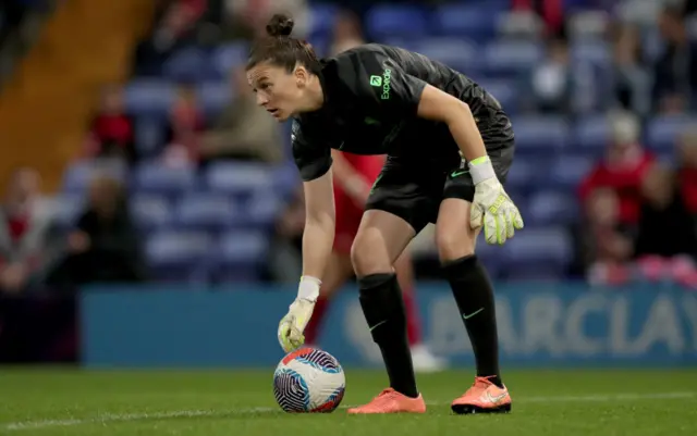 Lawes pauses as she sets the ball in place for a goal kick.