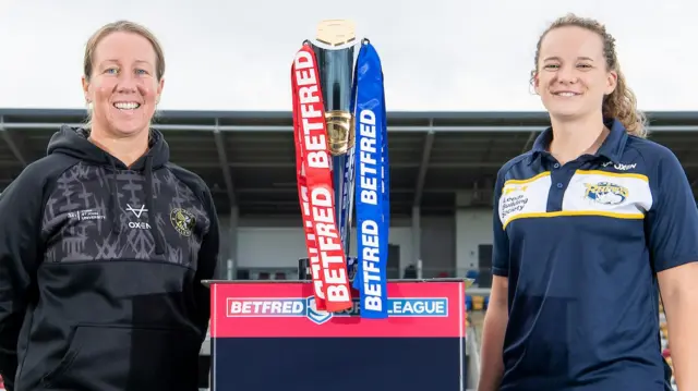 Lindsay Anfield and Lois Forsell stand either side of the trophy