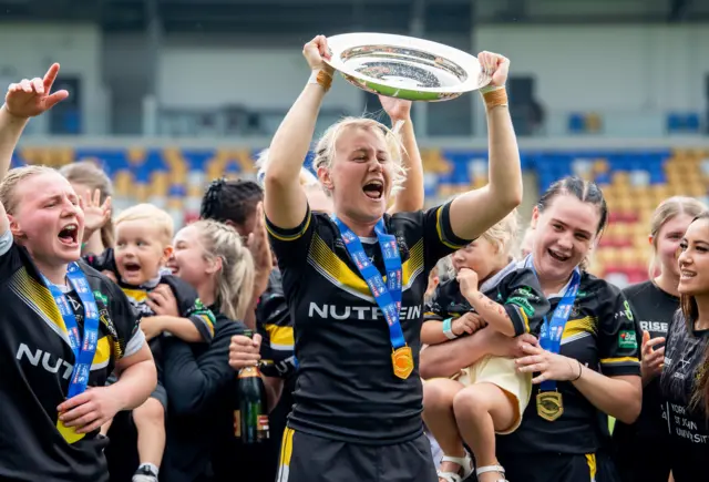 Tara Jane Stanley holds the League Leaders' Shield aloft for York