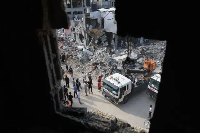 A truck clearing rubble from a building in Gaza strip