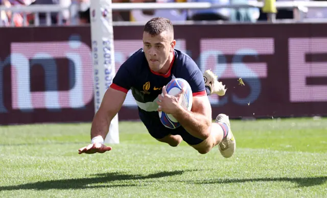 Emiliano Boffelli dives over the try line to score