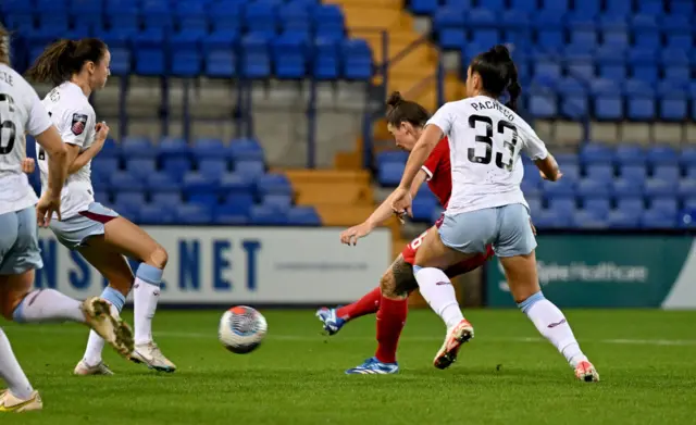 Flint fires home between Liverpool defenders to double the lead.