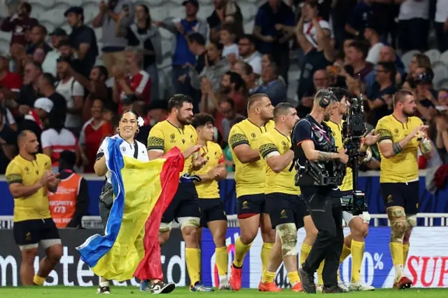Romania teammates do a lap after the game